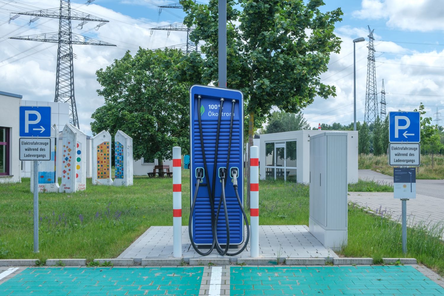 An electric vehicle charging station with two charging cables in a parking area