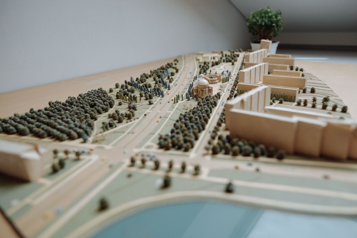A scale architectural model of a city district with buildings, roads and trees