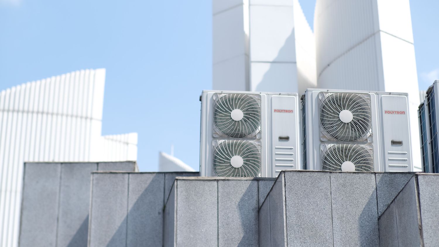 Two large air-conditioning condenser units on a building roof