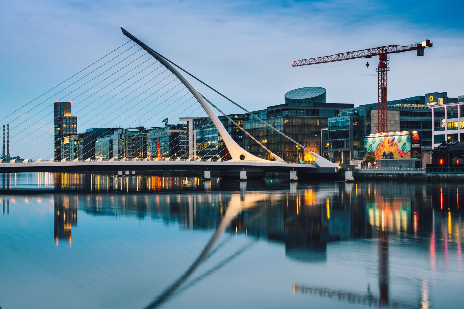 The Samuel Beckett Bridge and the Dublin Docklands at twilight, reflected in the River Liffey