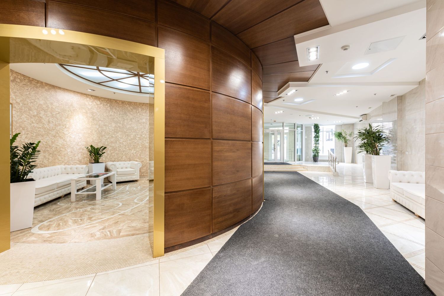 A hotel corridor with curved timber wall panels