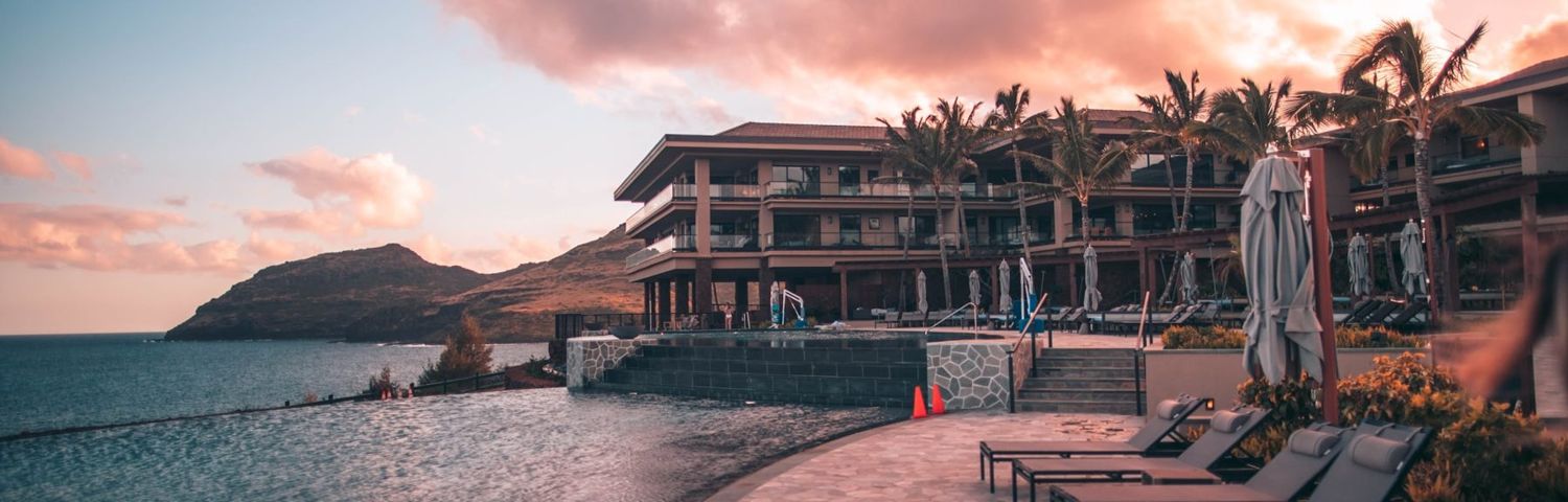 A coastal resort building at sunset