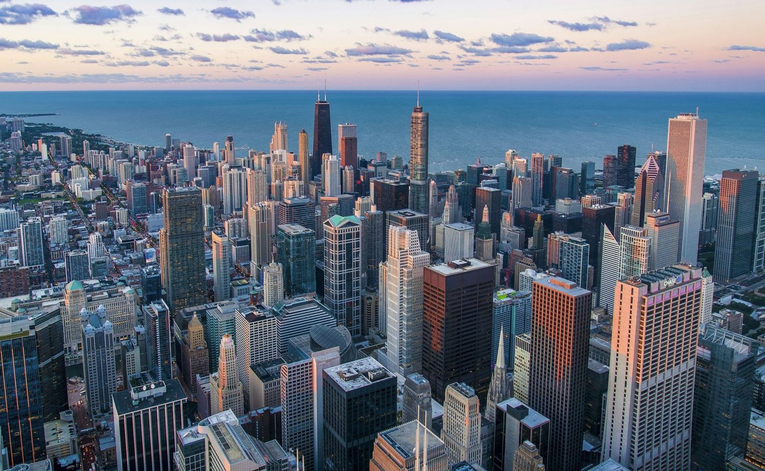An aerial view of a city skyline beside a lake